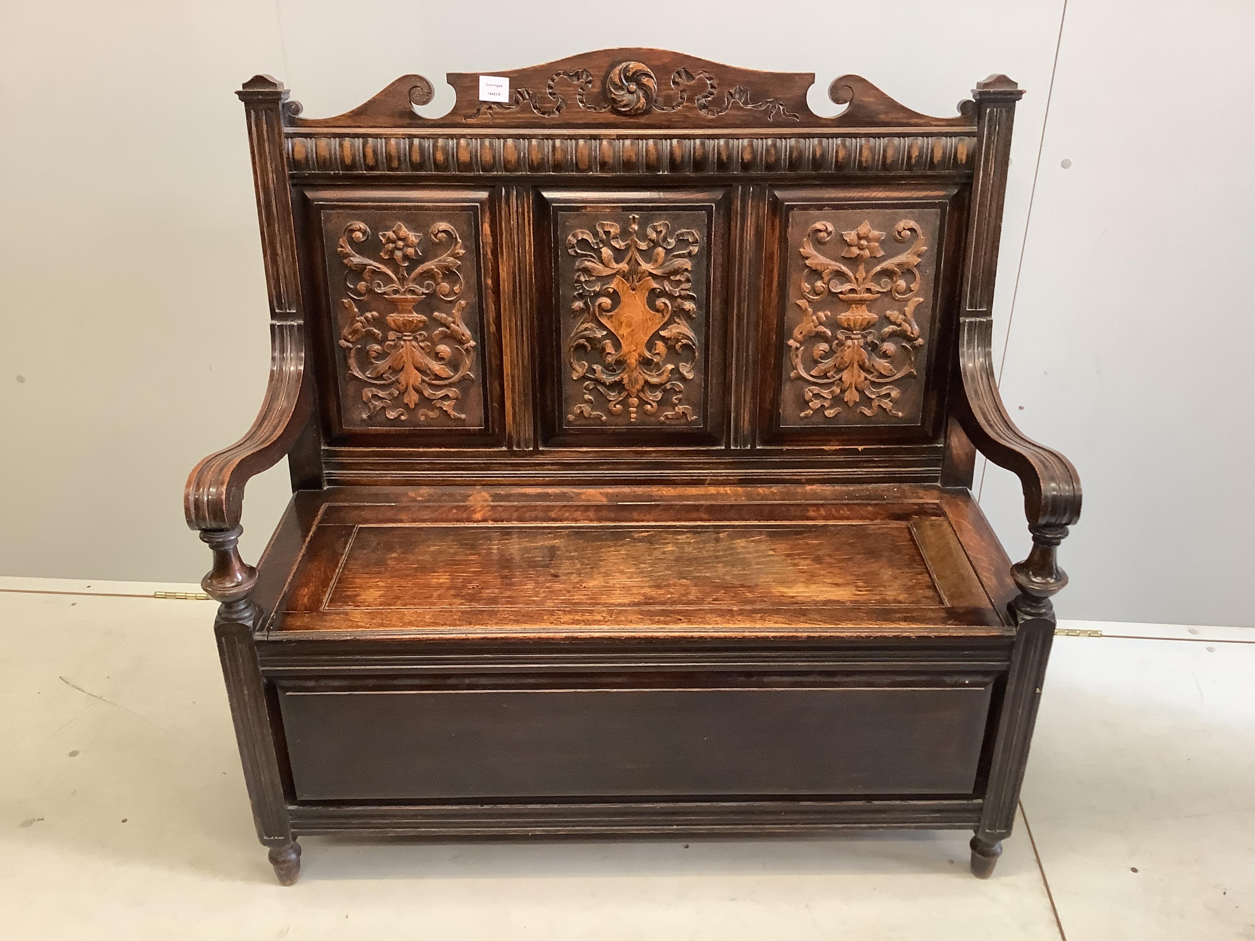 A late Victorian oak box seat settle, width 107cm, depth 44cm, height 109cm. Condition - fair